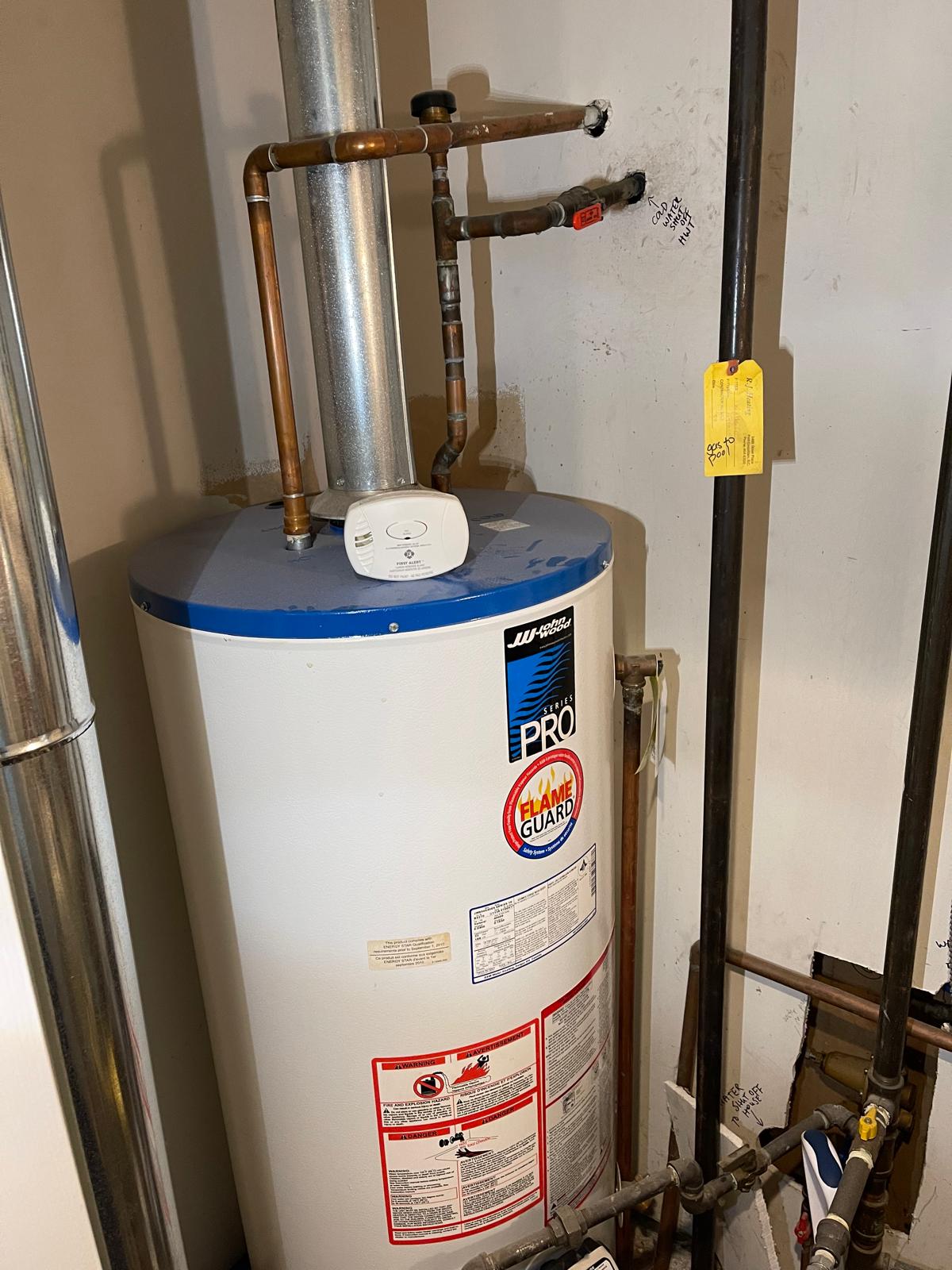 Technician servicing gas water heater in Richmond